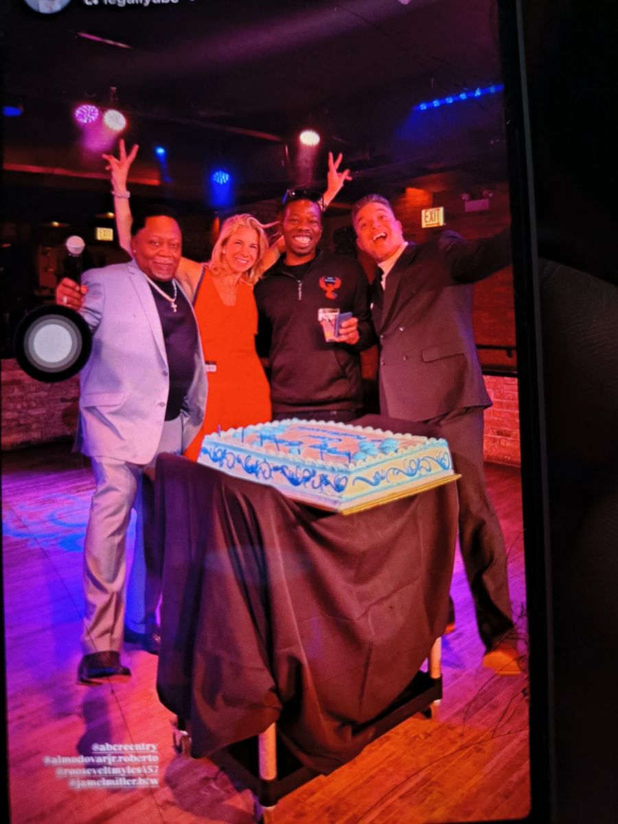 Jamel Miller and friends celebrating behind a cake at an ABC Reentry event