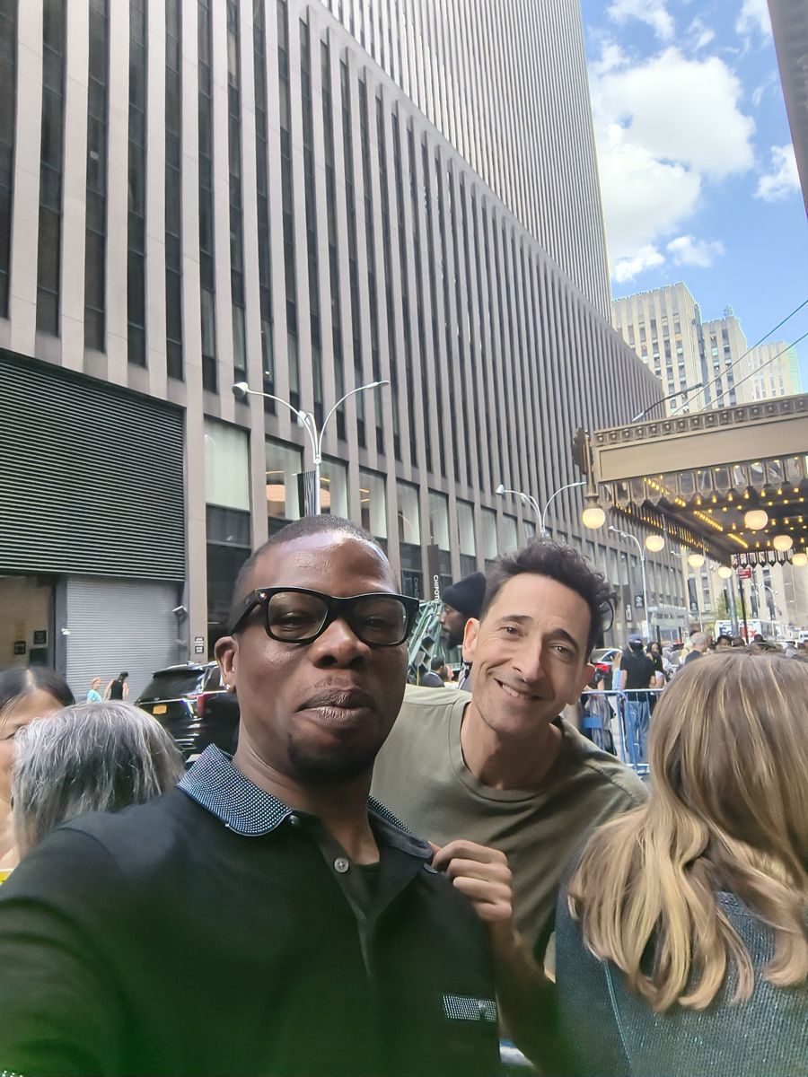 Jamel Miller taking a selfie on a New York City street outside Radio City Music Hall